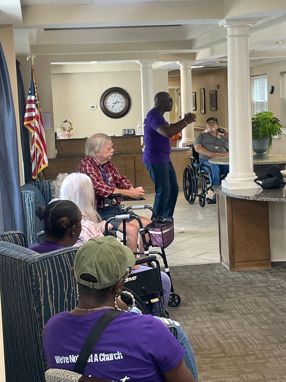 Nursing home residents listening and sharing a moment with Kingdom Cultural Center volunteers during an outreach visit.
